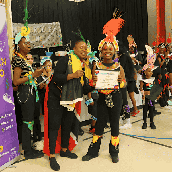 S.O.C.A. youth celebrating with certificates in Mas costume