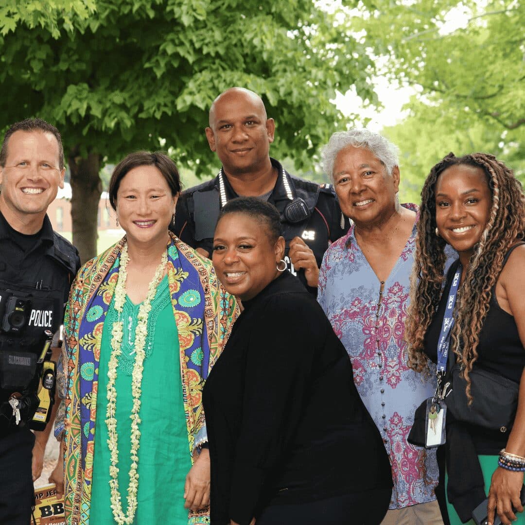 Community members and partners gathered together outdoors